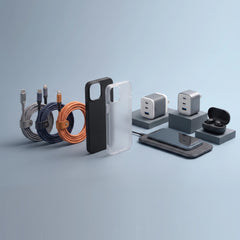 A set of smartphone accessories arranged on a light blue studio background, including coiled cables in gray, navy, and orange, a black and clear phone case, two silver power adapters on gray blocks, a smartphone lying on a charging pad, and a black earbud case open to show the inside.