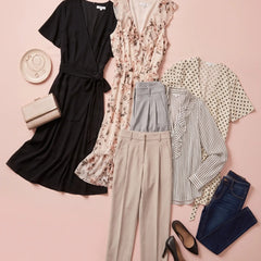 A styled flat lay of women's clothing on a soft pink background, including a black wrap dress, a beige floral sleeveless dress, a cream polka-dot cardigan, a striped blouse, gray pleated trousers, blue jeans, black heels, and a small beige clutch.